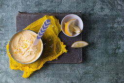 Lemon ice cream in a bowl with a spoon