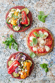 Low-carb mini pizzas (vegan mozzarella with a chickpea base, and grilled vegetables with a beetroot base)