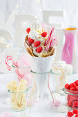 A bubble waffle with candy canes, foam strawberries and meringues