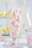 Pink, white and yellow striped marshmallows in a jar