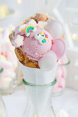 A bubble waffle with strawberry ice cream and unicorn decorations
