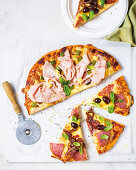 Pizza with deli, salami, pineapple and olives