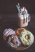 Different variations of the sweet donuts and cream coffee, selective focus