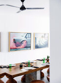 Laid table made of teak and stool, photo art on the wall