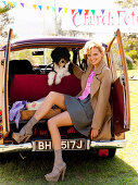 A blonde woman sitting in a car