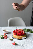 A basil cake with fresh strawberries, drizzled with mint syrup