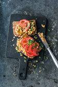 Scrambled eggs on toast with anchovies and tomatoes