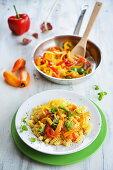 Spiral pasta with colourful pepper strips and basil