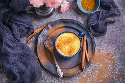 Golden milk turmeric latte served in a blue cup