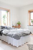 Romantic bed with valance in simple bedroom