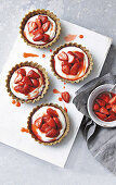 Sticky strawberry almond tarts