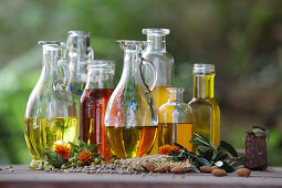 Various oils and oil extracts in bottles and carafes