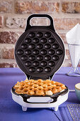 Crispy baked bubble waffles in a waffle iron