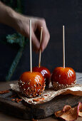 Toffee apples with chopped nuts and salted pretzels