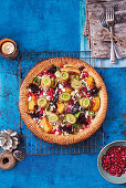 The ultimate Vegetarian Christmas Pie with courgette ribbons, butternut squash, beetroot and leeks, topped with feta cheese and pomegranate seeds