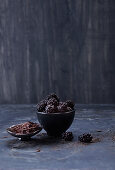 Blackberries and chocolate shards in black bowls
