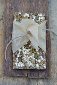 A granola bar with pistachios, sunflower seeds and sesame seeds