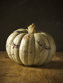 Pumpkin decoupaged with cut-out moths