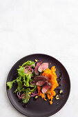 Sumac-crusted lamb with carrot smash and mint salad