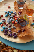 An autumnal table decoration made from painted acorns