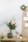 Bouquet of flowers in glass vase on rustic wooden table