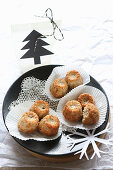 Mini muffins on a lace doily with a cut-out Christmas tree