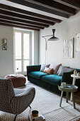 Various upholstered furniture in living room with wood-beamed ceiling