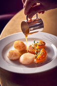 Scallops and pumpkin drizzled with sauce