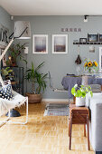 Eclectic mixture of styles in living-dining room in shades of grey