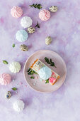 Slice of a Polish Easter cake with colorful meringues