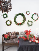 Wreaths of various sizes above bench with cushions