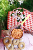 A girl having a picnic with tomato cream and sesame bread