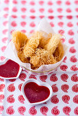 Kataifi coated chicken strips with dips in heart shaped bowls