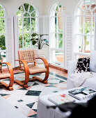 Designer chairs in the winter garden with arched windows