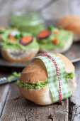 A sandwich with pea hummus, carrots and spring onions
