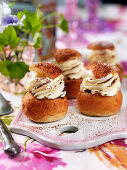 Semla (yeast pastries with whipped cream and cocoa powder, Sweden)