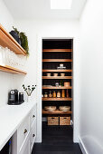 Narrow white room with view into pantry
