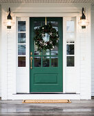 Front door decorated with Christmas wreath