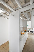 Kitchen in open-plan interior with rustic ceiling beams