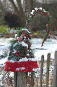 Coniferous arrangement tied together as a pointed cap