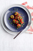 Vine tomatoes stuffed with anchovies, olives and capers