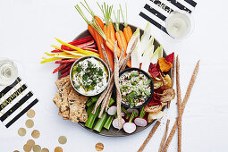 A raw food platter with dips and grissini for New Year's Eve