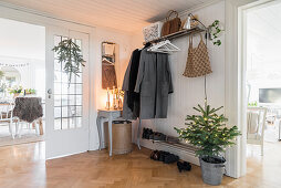 Christmas tree and arrangement of candles in hallway