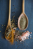 Various spices with two wooden spoons