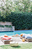 Lying with pillows by the pool