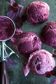Homemade cherry yoghurt ice cream: ice cream scoops with an ice cream scoop (top view)