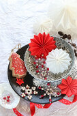 Stars and snowflakes made from beads and folded paper in stacked bowls