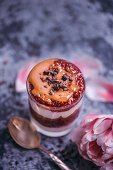 Peanut butter and raspberry chia jam parfait dessert served in a glass