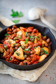 Turkey pan with beans and tomatoes in a cast iron pan