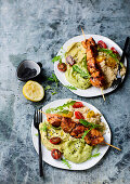 Chicken skewers with couscous, hummus and avocado purée